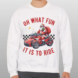 Person wearing a white sweatshirt with a graphic of Santa driving a car and text 'Oh what fun it is to ride' on a gray background.
