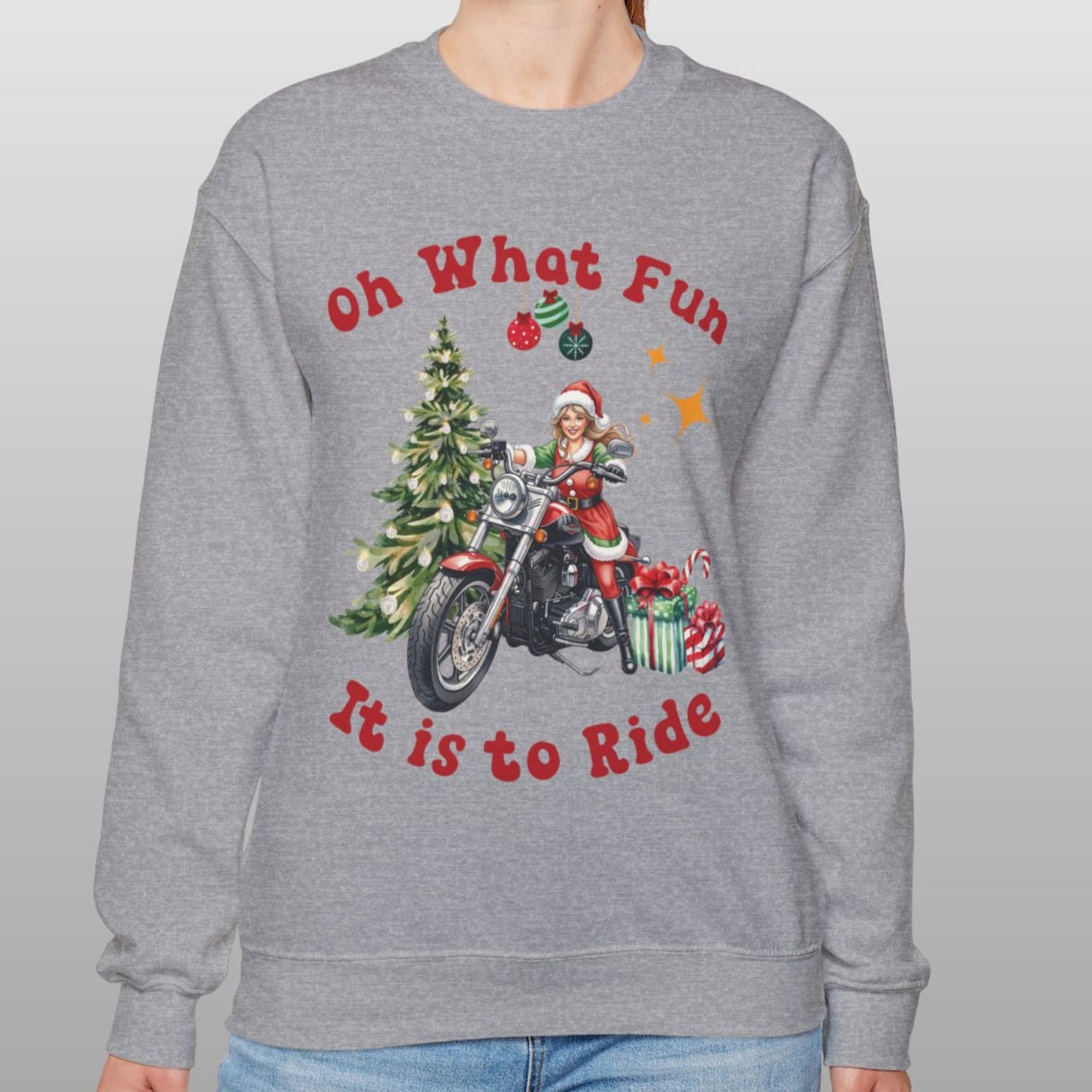 Person wearing a gray sweatshirt with Christmas-themed design and text.