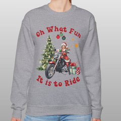 Person wearing a gray sweatshirt with Christmas-themed design and text.