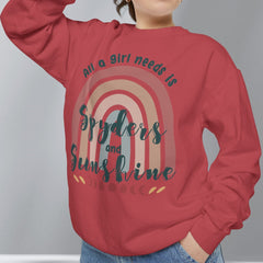 Person wearing a red sweatshirt with a rainbow design and text against a gray background
