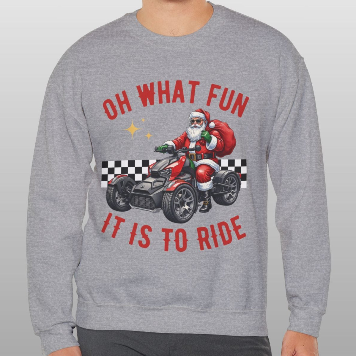 Person wearing a gray sweatshirt with Santa Claus graphic and text on a plain background