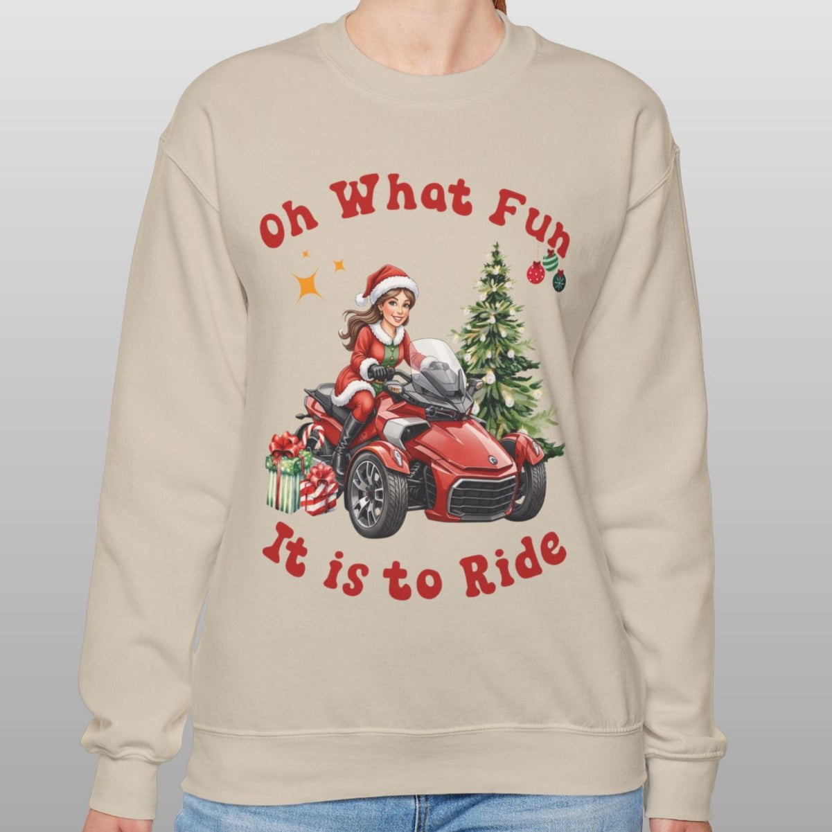 Person wearing a beige sweatshirt with Christmas-themed design and text.