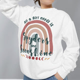 Person wearing a white sweatshirt with a rainbow design and text, standing against a plain background.