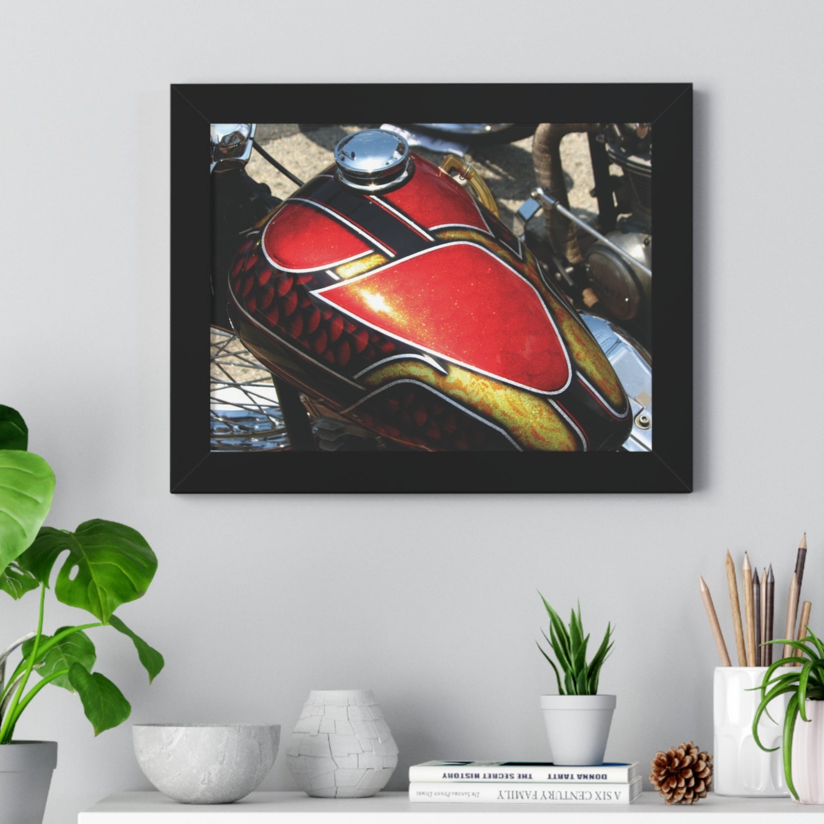 Framed poster print of a close-up image of a red, black, and gold chopper motorcycle gas tank, displayed on a wall.