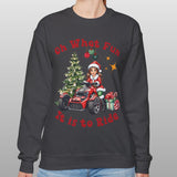Person wearing a dark gray sweatshirt with Christmas-themed design on a plain background