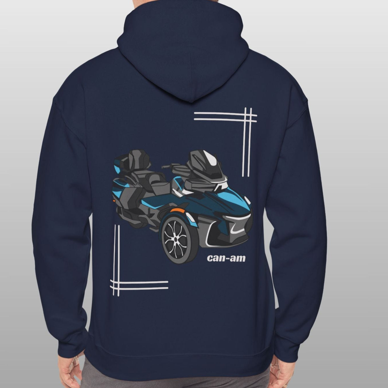 Person wearing a navy hoodie with a graphic of a vehicle on the back against a gray background