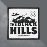 Patch with 'The Black Hills, South Dakota' text and mountain design on a gray background