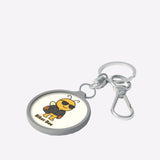 Keychain with a cartoon bee design on a white surface