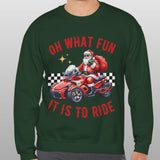 Person wearing a green sweatshirt with Santa Claus and a car graphic, text 'Oh what fun it is to ride' on a gray background