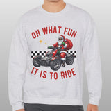 Person wearing a gray sweatshirt with a Christmas-themed design on a plain background