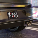 Car exhaust system with a 'Spyder Ryder' sticker on a blurred background