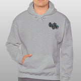 Man wearing a gray hoodie with a small logo on a plain background