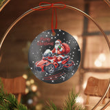 Decorative Christmas ornament with Santa Claus on a motorcycle, placed on a wooden slice with greenery and red ornaments.