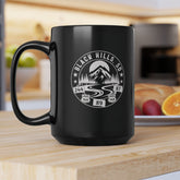 Black mug with a white graphic design on a kitchen counter