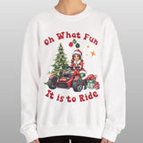 Person wearing a white sweatshirt with Christmas-themed design and text.