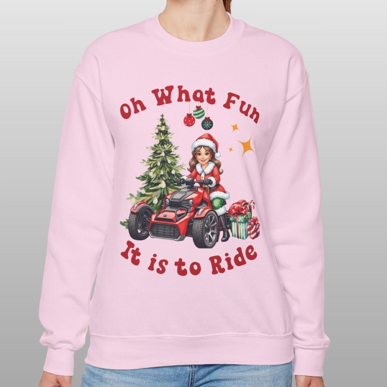 Person wearing a pink sweatshirt with Christmas-themed design and text.