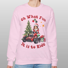 Person wearing a pink sweatshirt with Christmas-themed design and text.