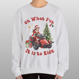 Person wearing a Christmas-themed sweatshirt with graphics and text on a plain background