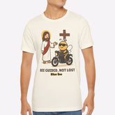 Man wearing a white t-shirt with a graphic design on a plain background