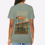 Person wearing a t-shirt with a graphic of a motel and motorcycle on the back.