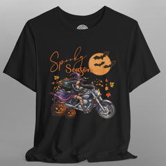Black t-shirt with Halloween-themed design featuring a witch on a motorcycle and pumpkins.