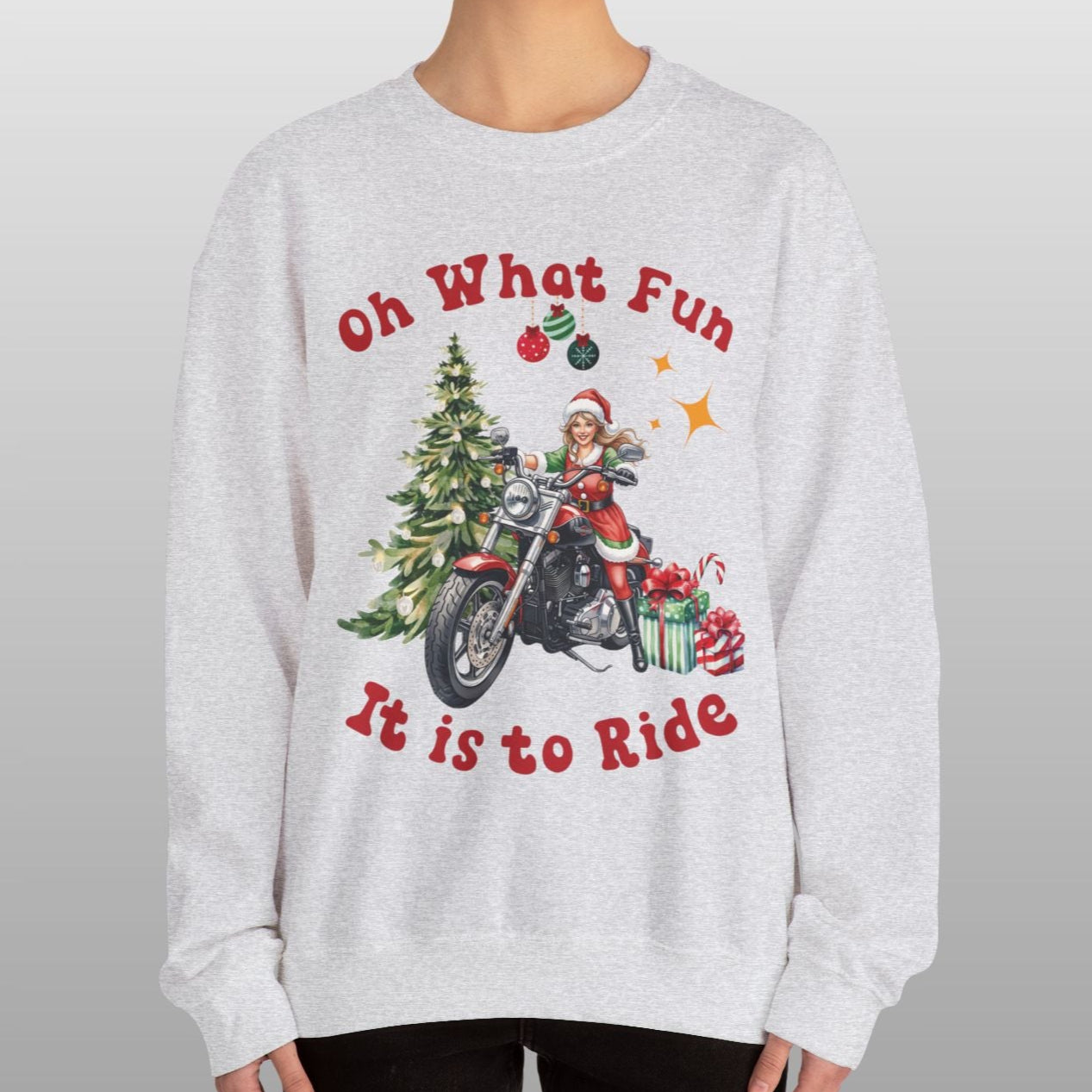Person wearing a gray sweatshirt with Christmas-themed design and text.