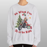 Person wearing a gray sweatshirt with Christmas-themed design and text.