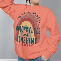 Person wearing a coral sweatshirt with a graphic and text, standing against a plain background