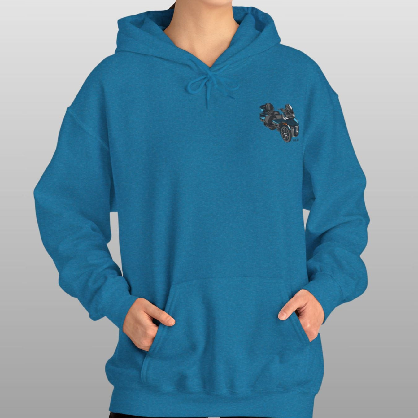 Person wearing a blue hoodie with a small design on a plain background
