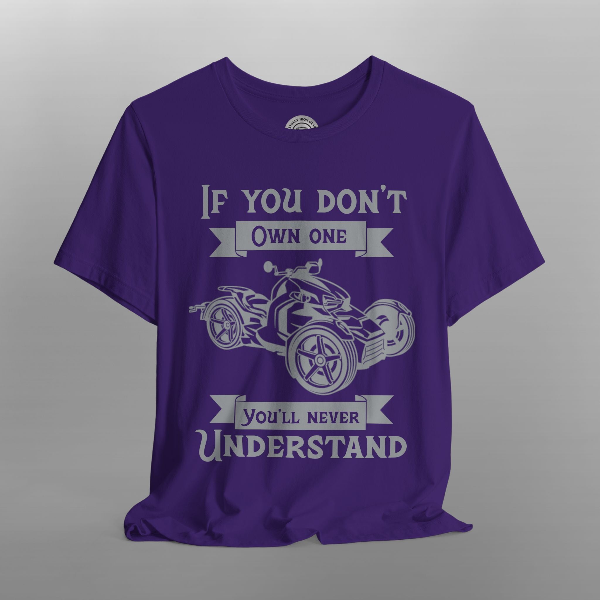 Purple t-shirt with graphic and text on a gray background