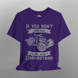 Purple t-shirt with graphic and text on a gray background