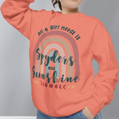 Person wearing a coral sweatshirt with a rainbow design and text on a gray background