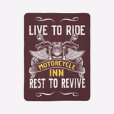 Decorative sign with motorcycle design and text 'Live to Ride, Motorcycle Inn, Rest to Revive' on a green wall.