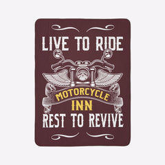Decorative sign with motorcycle design and text 'Live to Ride, Motorcycle Inn, Rest to Revive' on a green wall.