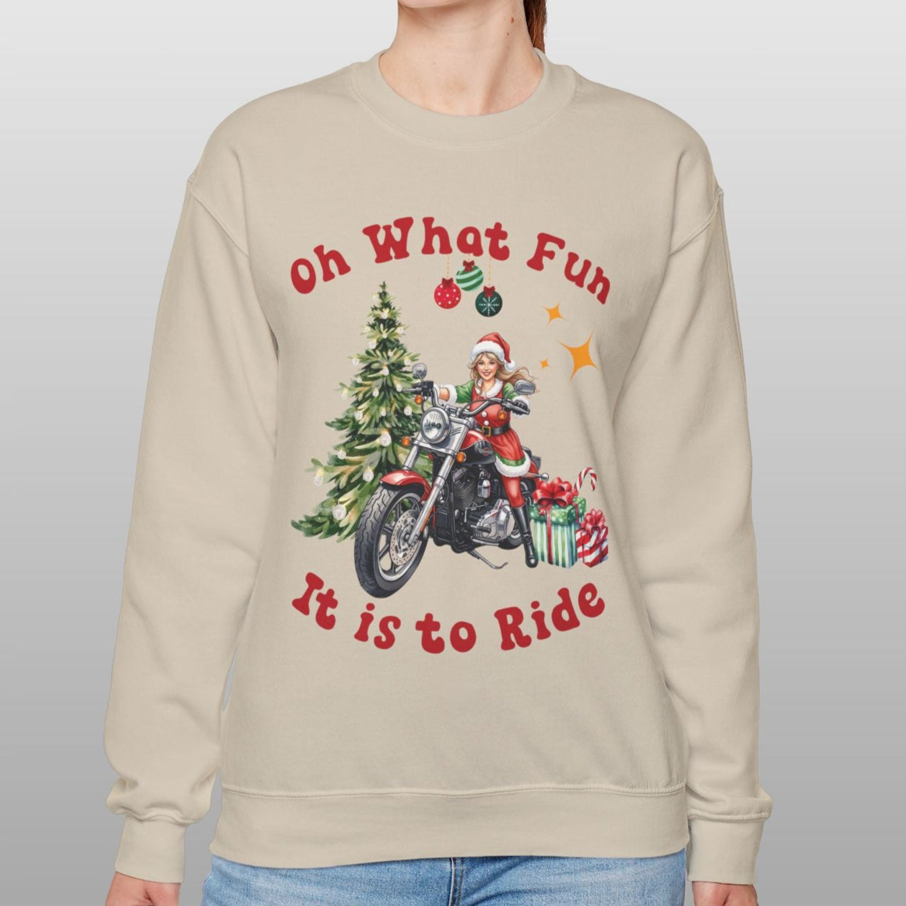 Person wearing a beige sweatshirt with Christmas-themed design and text.
