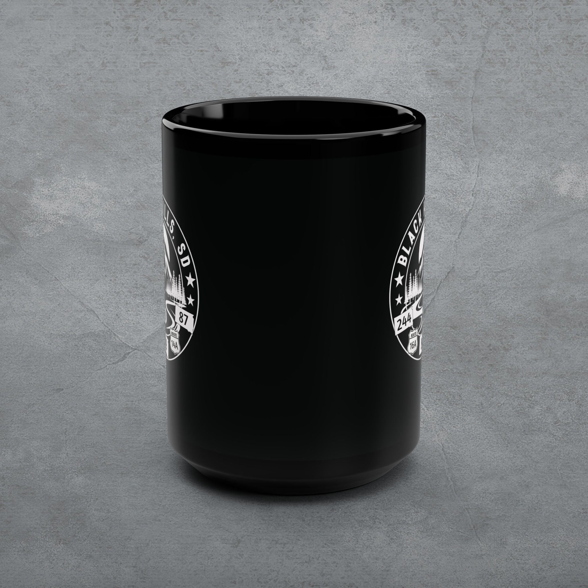 Black mug with white logo on a gray background