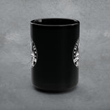 Black mug with white logo on a gray background