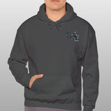 Man wearing a dark gray hoodie with a logo on a light gray background