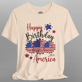 Beige t-shirt with 'Happy Birthday America 2026' text and graphics on a gray background