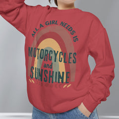 Person wearing a red sweatshirt with a graphic and text, standing against a plain background