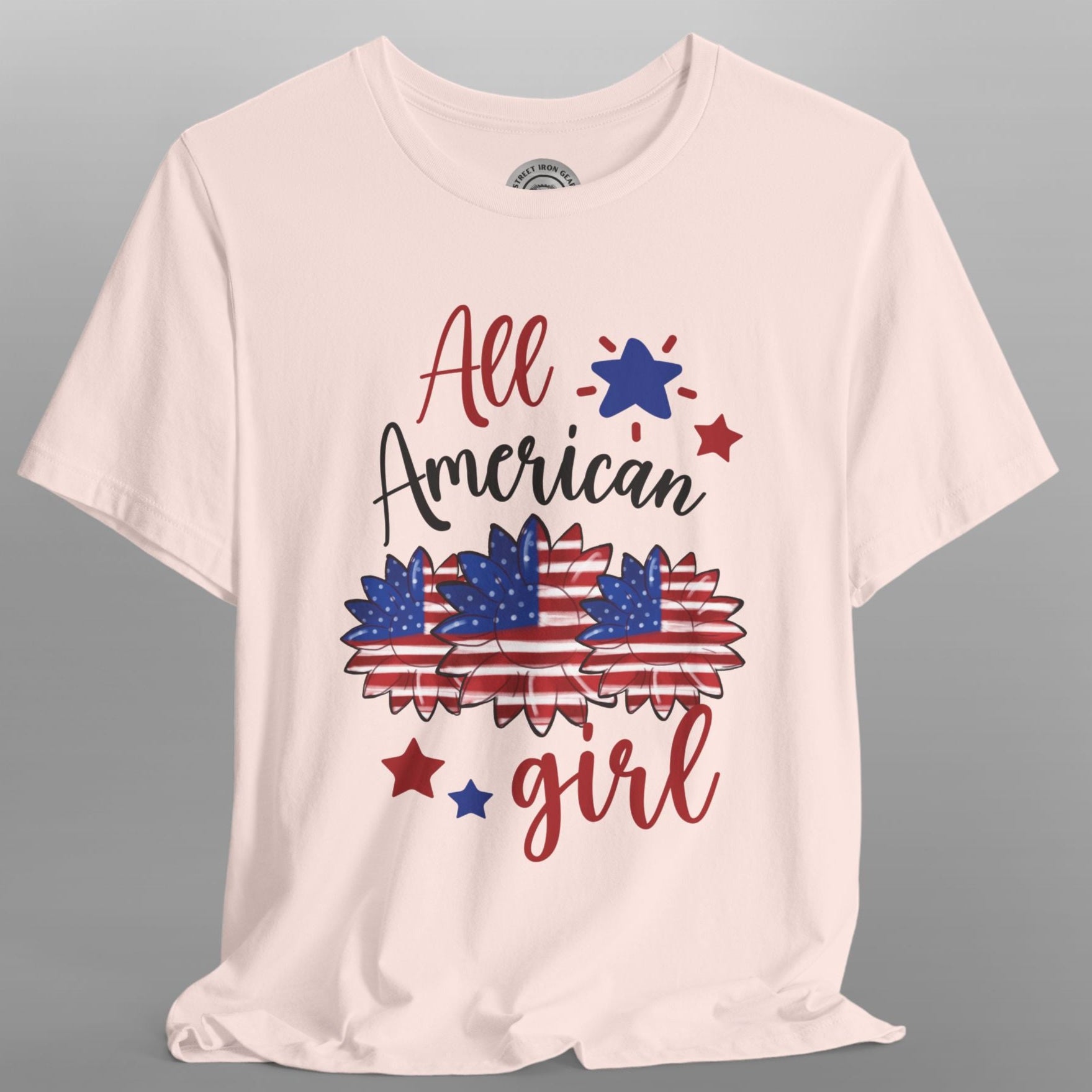 Pink t-shirt with 'All American Girl' text and graphics on a gray background