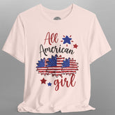 Pink t-shirt with 'All American Girl' text and graphics on a gray background