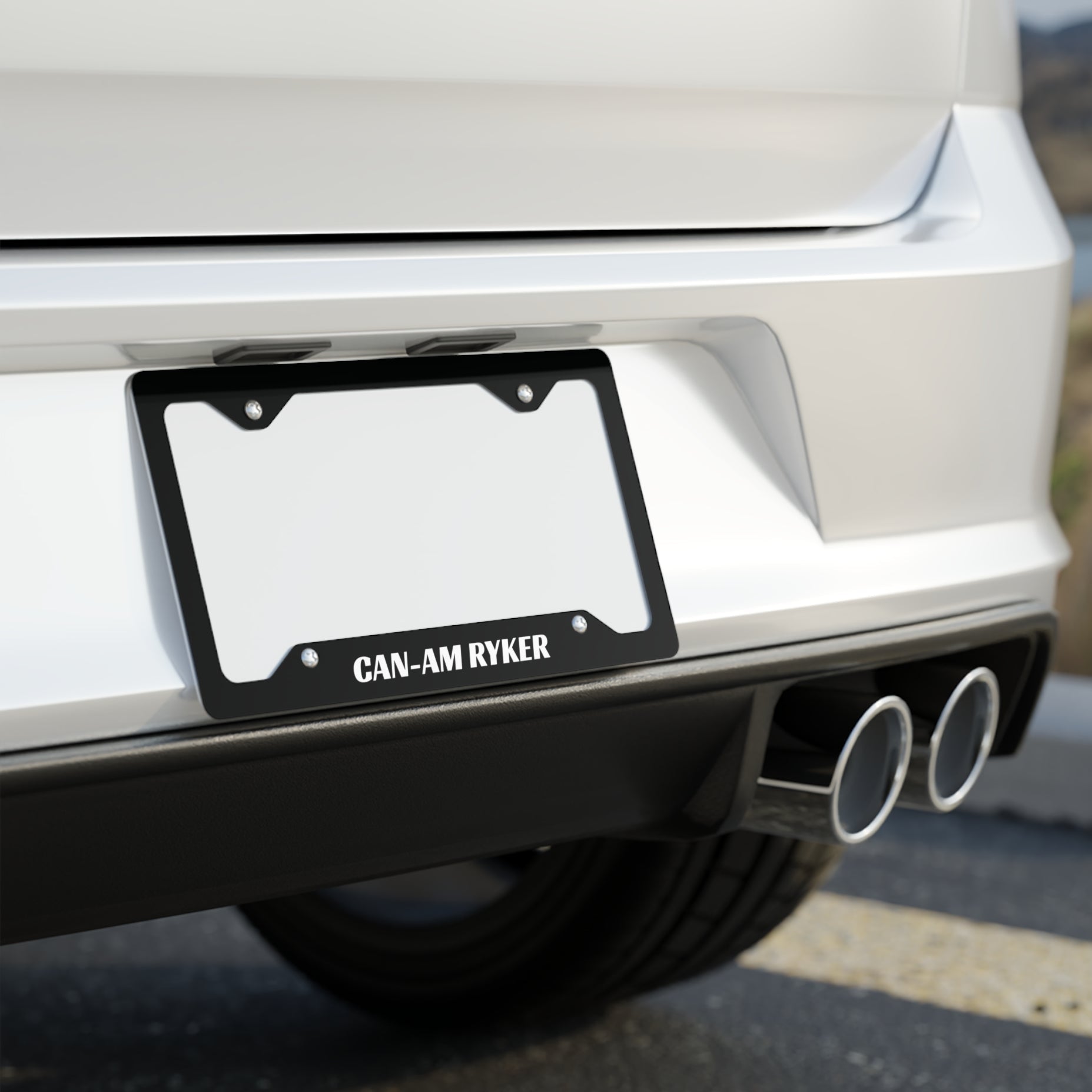 Car license plate with 'CAN-AM RYKER' on a white car, blurred background
