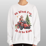 Person wearing a white sweatshirt with Christmas-themed design and text.
