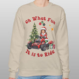 Person wearing a beige sweatshirt with Christmas-themed design and text.