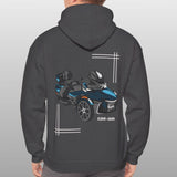 Person wearing a dark gray hoodie with a graphic of a vehicle on the back against a light gray background