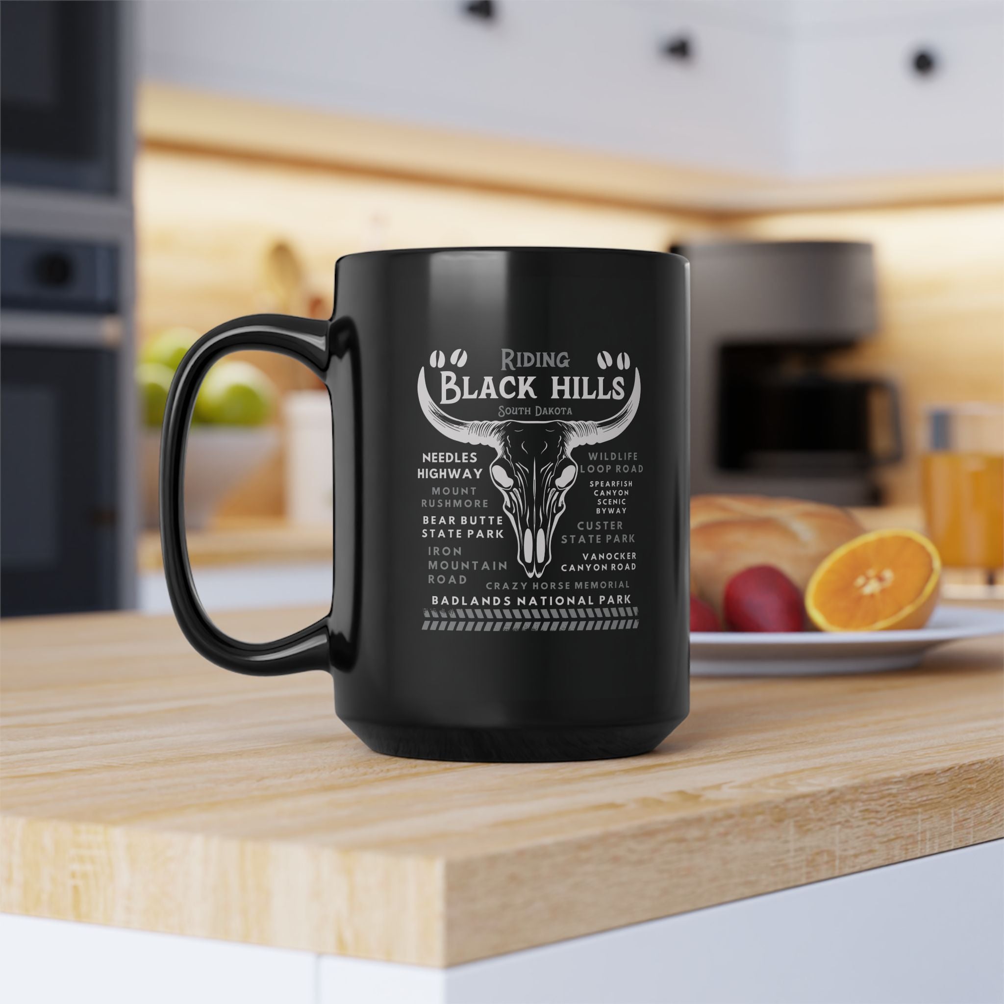 Black mug with white text design on a kitchen counter
