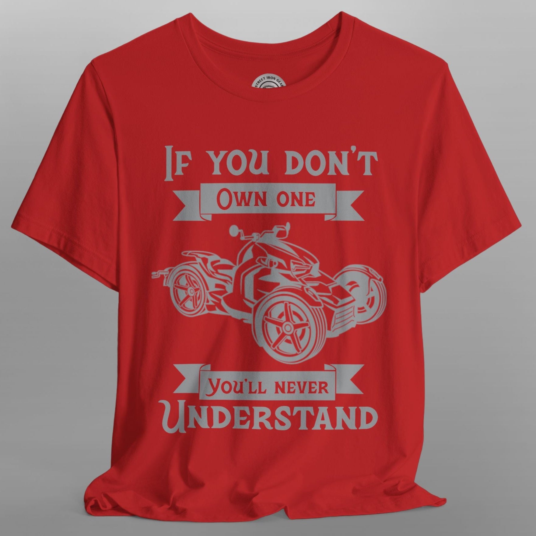 Red t-shirt with graphic design and text on a gray background