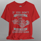 Red t-shirt with graphic design and text on a gray background