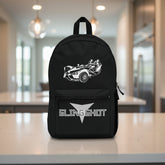 Black backpack with a white graphic of a vehicle and 'SLINGSHOT' text on a white background